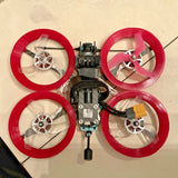 Cinewhoop drone kit with four red ducted propellers and central flight controller