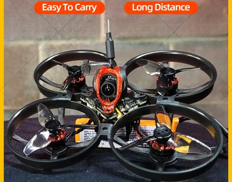 Micro quadcopter drone with four black propellers and central orange motor housing