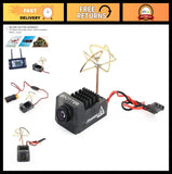 Black FPV camera module with small circular lens, rooftop antenna, and red/black wiring