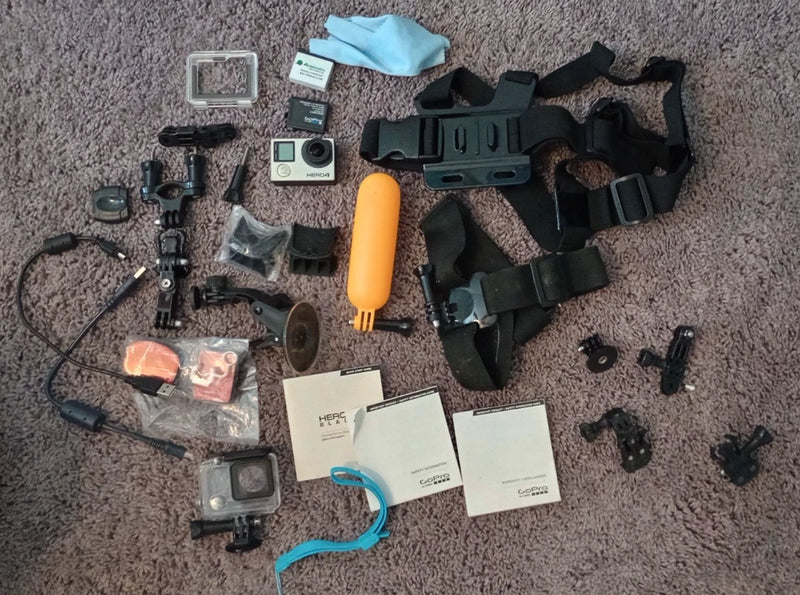 GoPro Hero 4 Black action camera bundle with mounts, housing, and accessory pieces