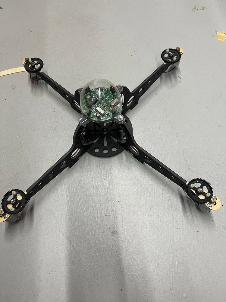 Vintage black quadcopter drone with four arms and central camera/sensor module