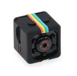 Black mini action camera with rainbow strap and front lens detail