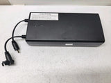 Black wireless rechargeable battery pack with attached power cable and plug