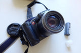 Fujifilm compact digital camera with lens and strap, plus battery pack