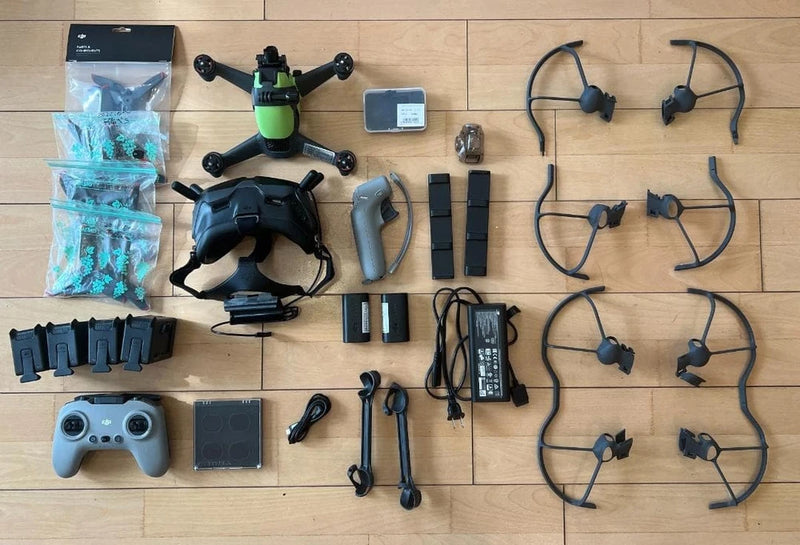 FPV drone kit with remote controller, goggles, batteries, and propellers