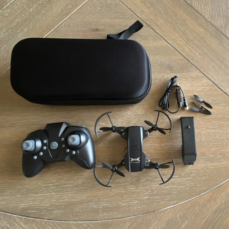 Quadcopter drone toy kit with controller, battery and black carrying case, accessories