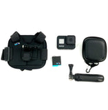 Black action camera with mount, hand grip, waterproof housing, and zip pouch