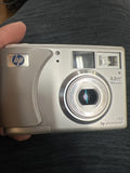 Silver HP digital camera front with lens, 3.2MP and 15x zoom, hp photosmart 735