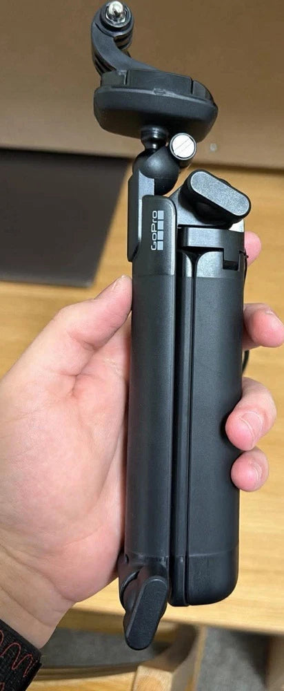 GoPro action camera on handheld grip, black, with mounting hardware