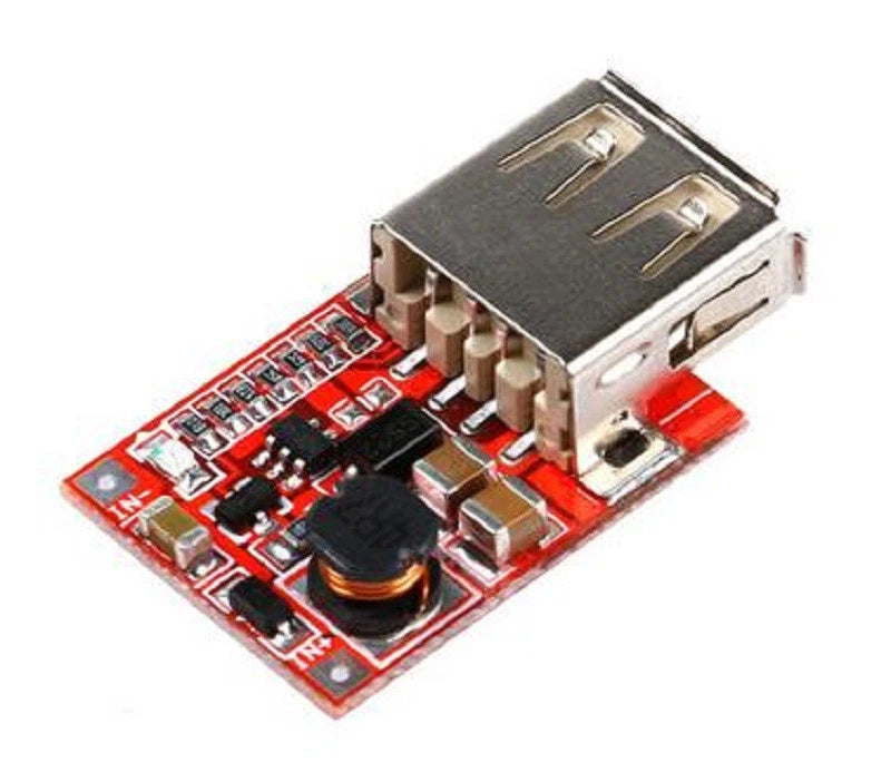 Step-up DC-DC converter USB charger module on red circuit board with capacitor and chips