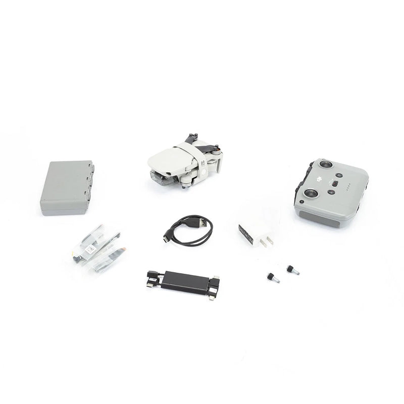 DJI Mini 2 Fly More Combo parts: drone, controller, batteries, cables, propellers.