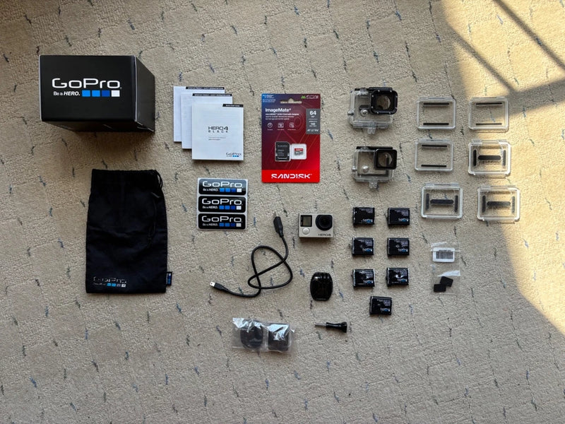 GoPro action camera bundle with black camera, waterproof housing, mounts, and accessories