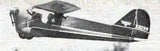 Dark gray RC airplane model, single-prop high-wing fuselage side view