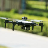Mini quadcopter drone with front camera and four landing legs