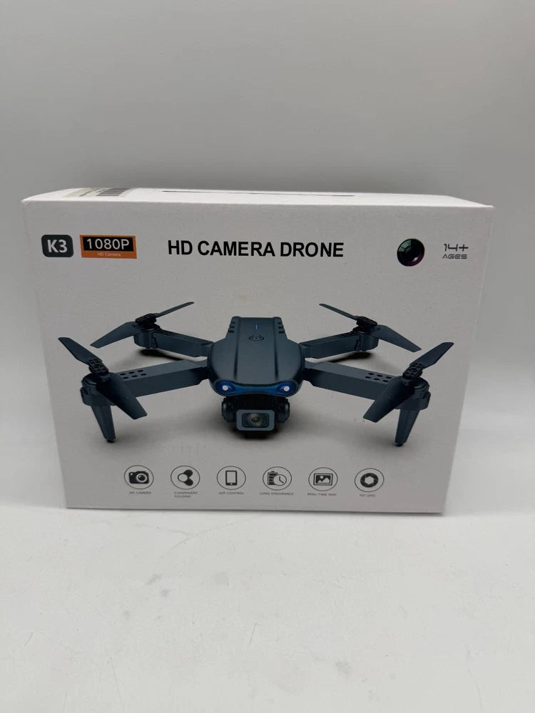 Black HD camera drone with four rotors and front camera, shown in packaging
