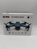 Black HD camera drone with four rotors and front camera, shown in packaging