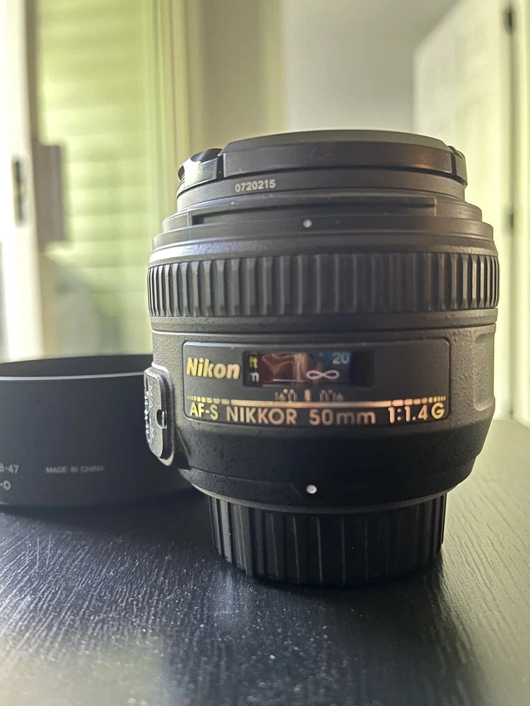 Nikon AF-S NIKKOR 50mm f/1.4G camera lens with hood, front view