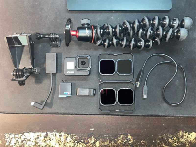 GoPro Hero 8 Black action camera kit with mounts, waterproof housing, cables, and frame screens