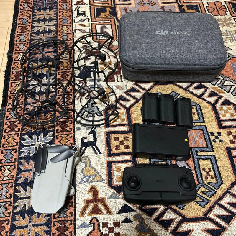 DJI Mavic drone with remote controller, three batteries, and gray carrying case