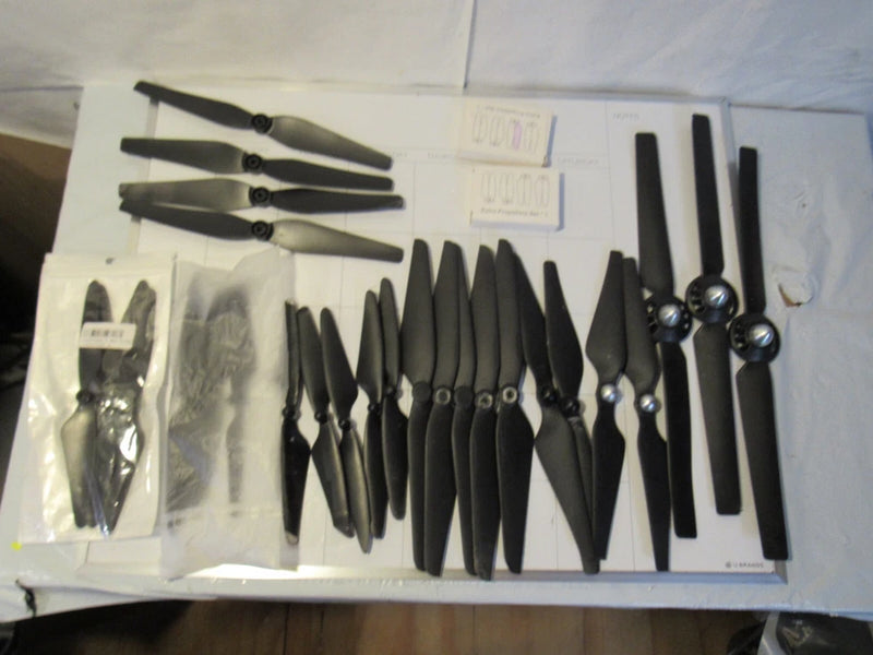 Assorted drone propeller blades lot with mixed black sizes and spare parts