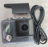 Waterproof action camera with front lens, LCD screen, and connected power cable