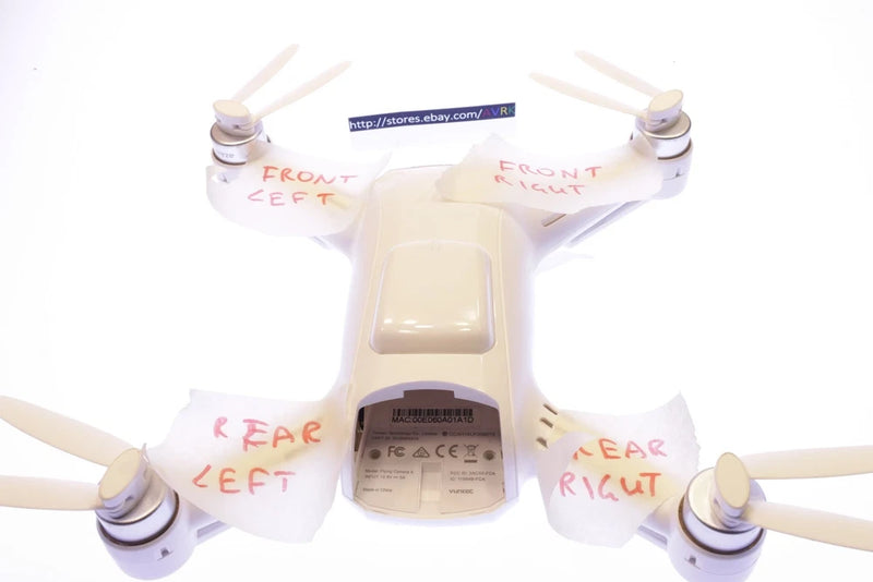 Quadcopter rear right motor with propeller blades, mounted on white drone frame