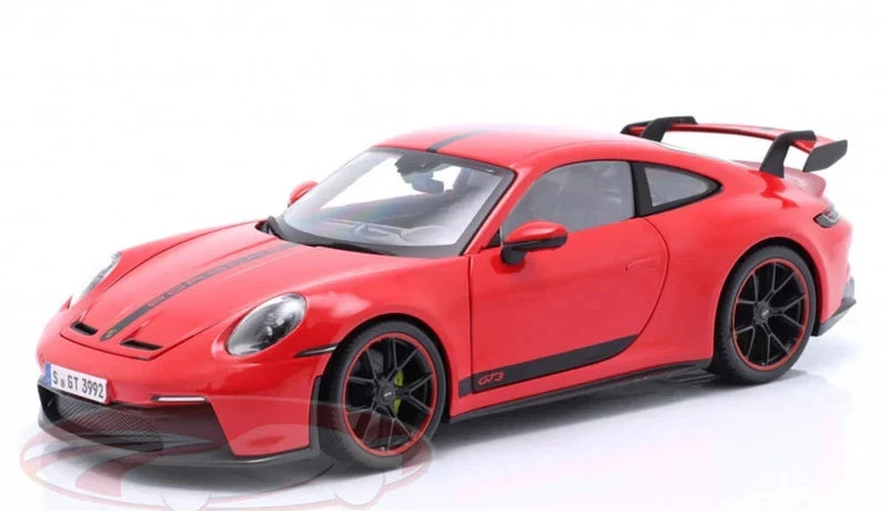 Red 1:18 scale Porsche 911 GT3 model car, front three-quarter view, black wheels