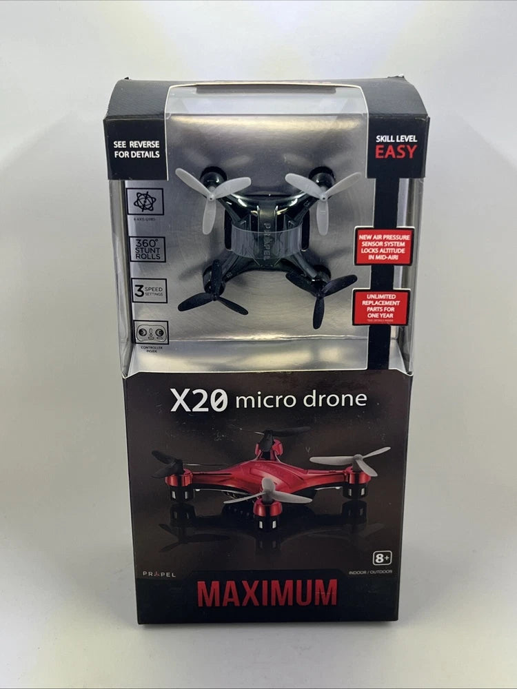 Black micro quadcopter drone in retail box, red prop accents