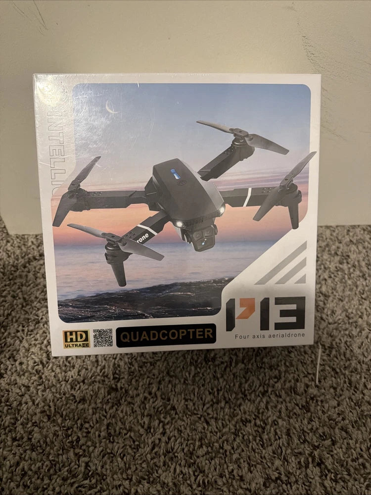 Quadcopter aerial drone on retail box, orange accents, four propellers