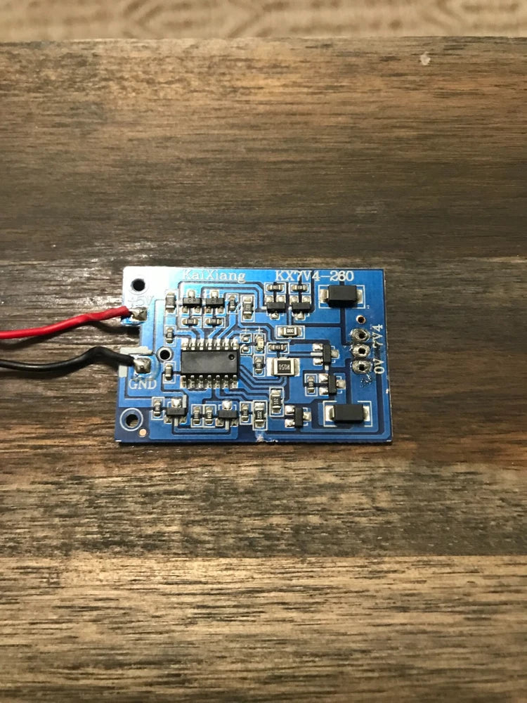 7V RC battery charging circuit board with wires, blue PCB and electronic components