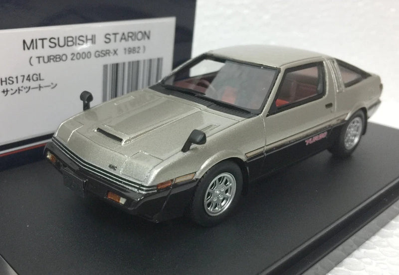 Silver Mitsubishi Starion turbo model car, front 3/4 view with black hood stripe