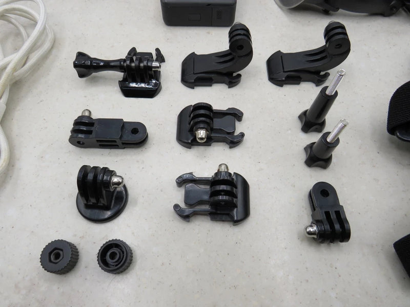 Black GoPro action camera mounting brackets and clamps with screws