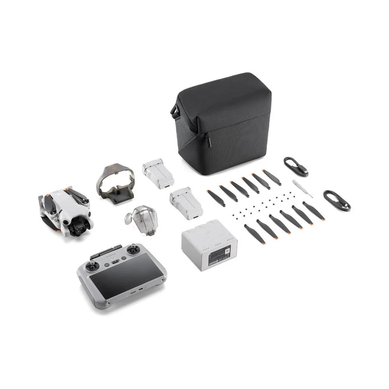 Camera drone kit with controller, batteries, propellers, and accessory bag