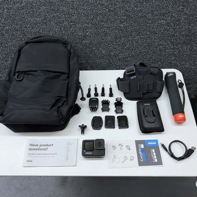 GoPro HERO9 action camera bundle with chest mount, handheld grip, battery, and carrying bag