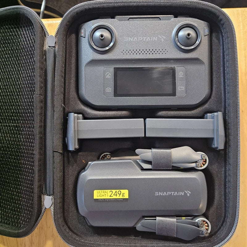 Snaptain P30 4K drone in protective case with controller screen and extra battery
