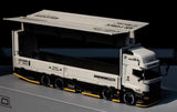 Limited model truck with white cab and black trailer, angled front view.