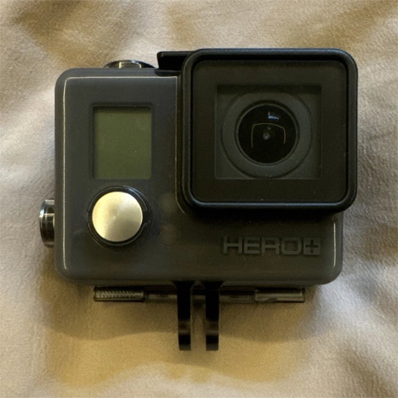 Black HERO+ action camera with front lens and protective housing, side control button