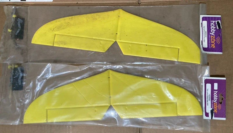 Yellow R/C airplane tail fins with accessories in clear plastic bag