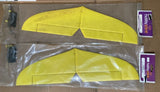 Yellow R/C airplane tail fins with accessories in clear plastic bag