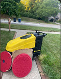 Tornado auto scrubber brush motor with yellow housing and two red scrub pads