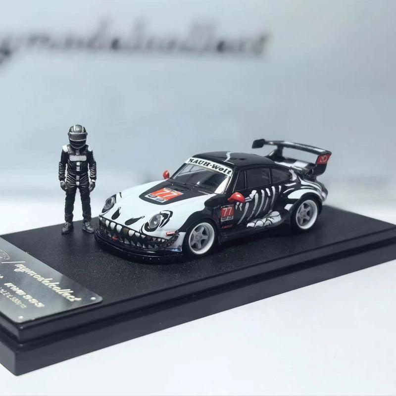 1:64 alloy race car model with black-and-white livery, on display base