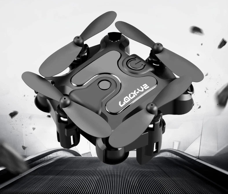 Mini folding quadcopter drone with four propellers, dark gray body and compact design