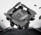 Mini folding quadcopter drone with four propellers, dark gray body and compact design