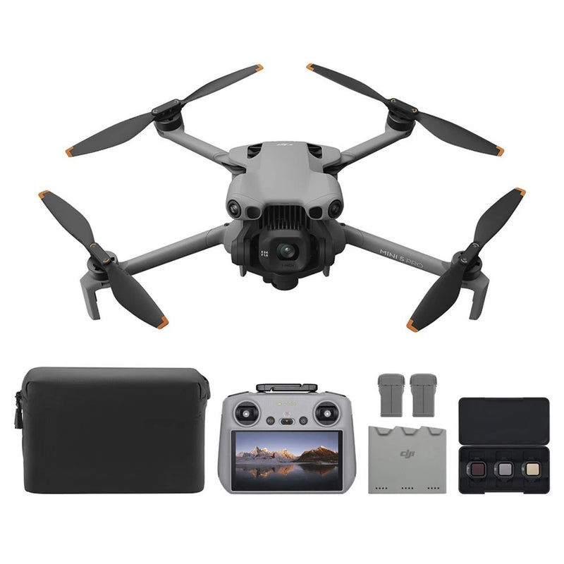 Gray quadcopter drone with 4 propellers, controller, batteries, and carrying case