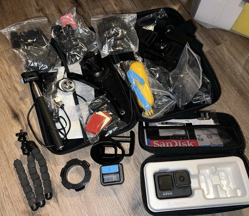 GoPro HERO 9 action camera accessories kit with mounts, case, cable, battery, and Sandisk storage