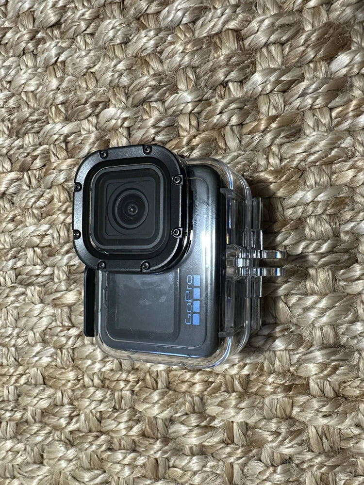 GoPro HERO11 Black action camera with clear protective housing and accessory mount