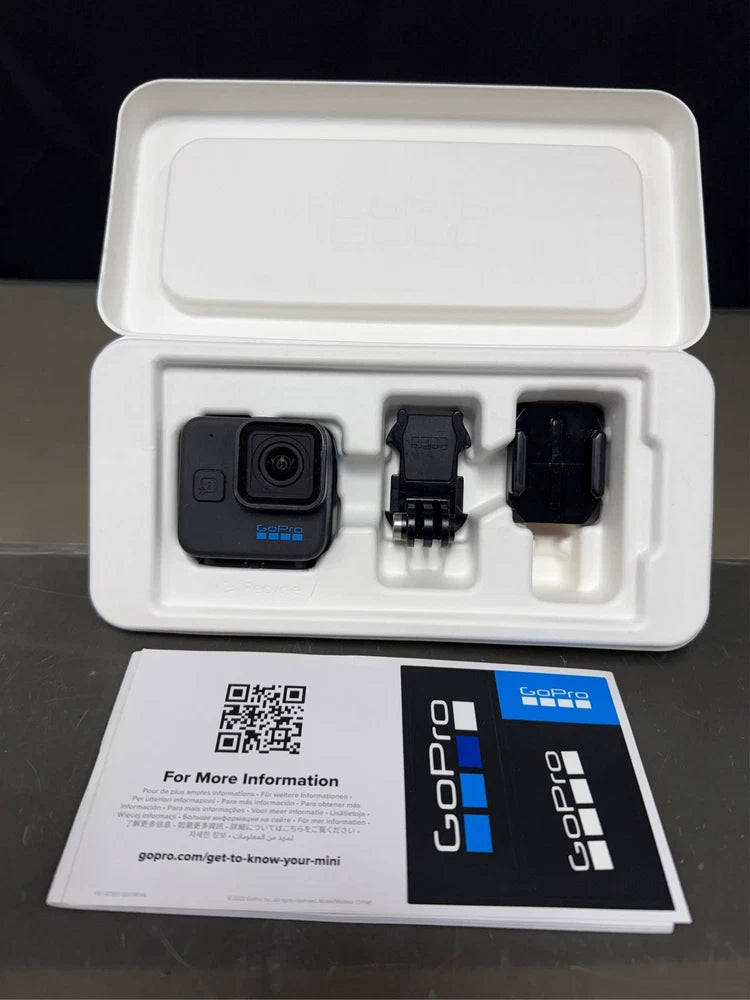 GoPro HERO11 Black action camera with mount accessories in open box