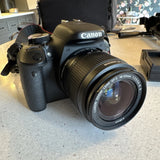 Canon DSLR camera with attached EFS 18-55mm IS II lens, black body