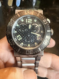 Men's Invicta chronograph wristwatch with black dial, gold-tone bezel, stainless steel bracelet