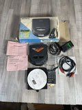Portable Sony Discman CD player with remote, cables, and paperwork; no battery